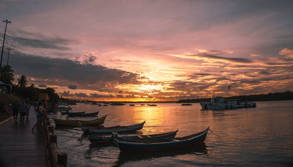 A mesmerizing sunset over a Brazilian bay with docked boats, capturing the golden hour ambiance.