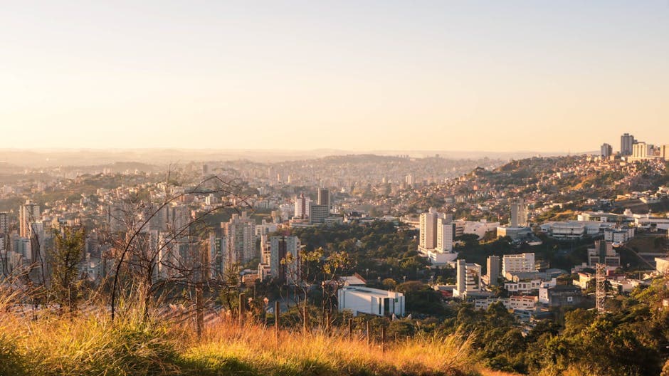 A scenic aerial view of Belo Horizonte in Minas Gerais, Brazil at sunset showcasing urban sprawl and greenery.