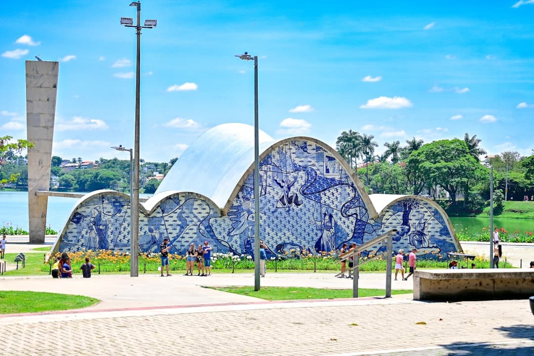a blue and white building sitting next to a lake