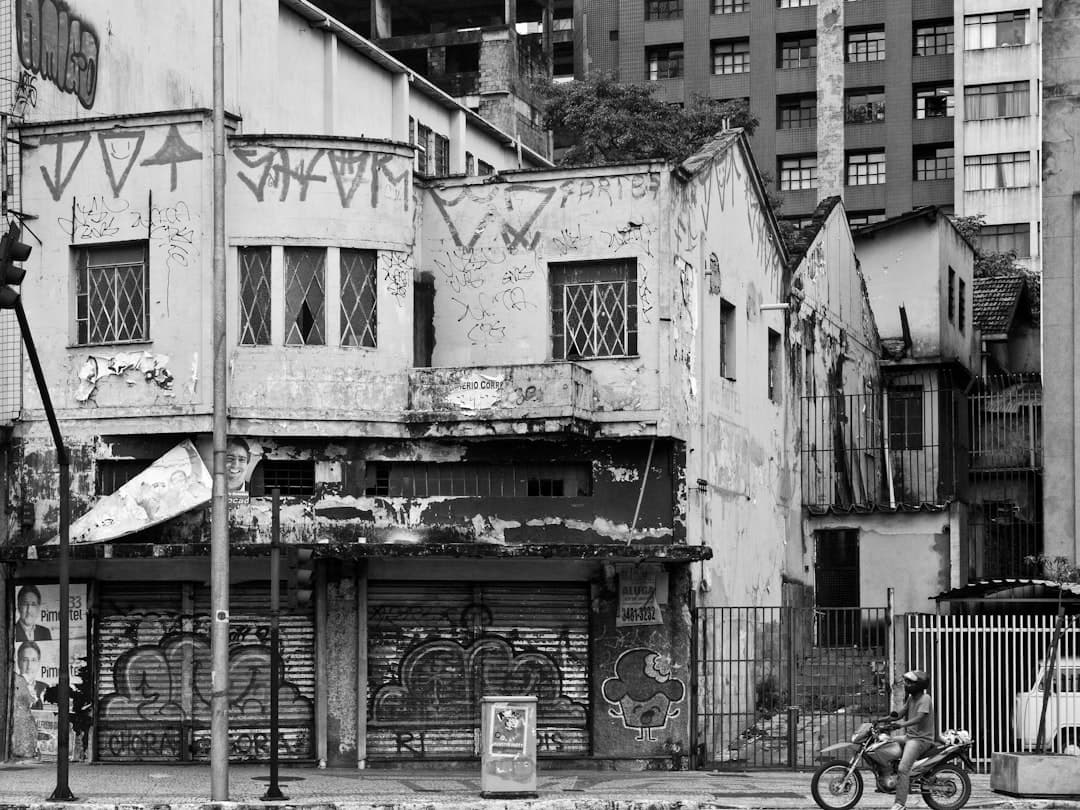 a motorcycle parked in front of a run down building
