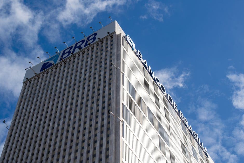 High-rise Banco de Brasília building with clear sky, capturing modern architecture against a vibrant blue background.