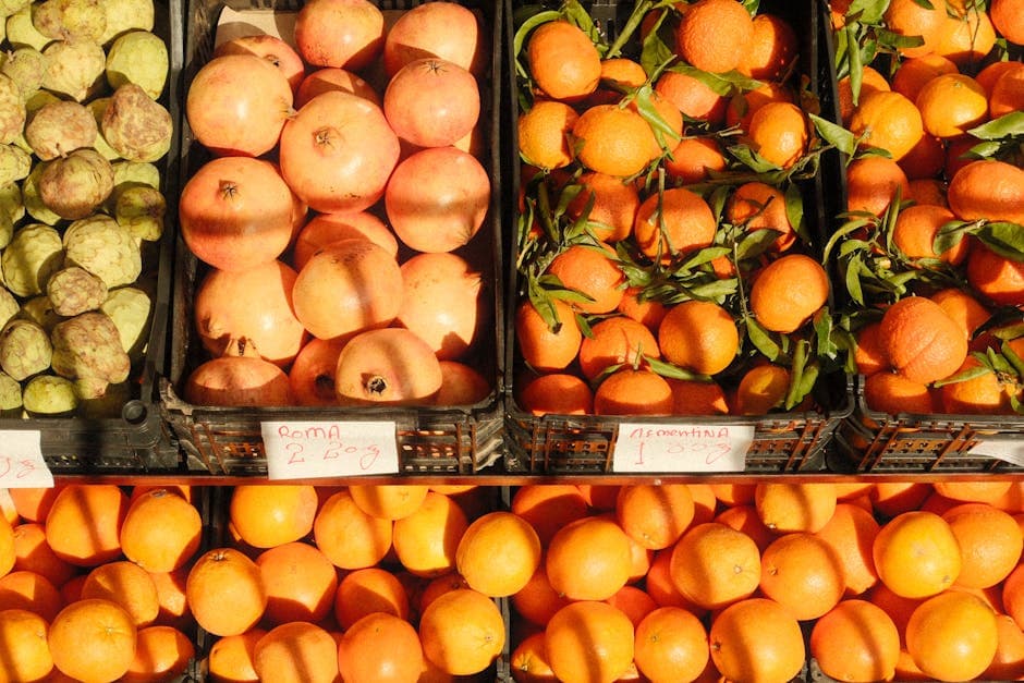 Colorful assortment of citrus fruits and pomegranates at a bustling Lisbon market.