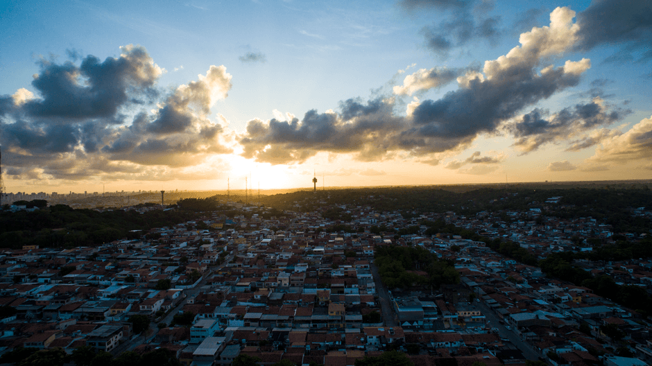 Stunning aerial view of Recife, Brazil at sunset with dramatic clouds and warm hues.