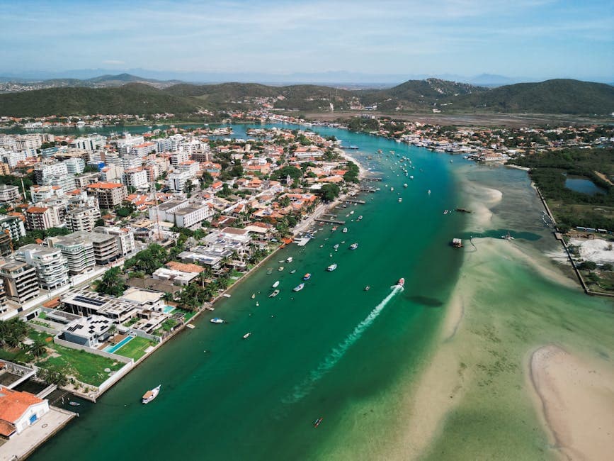 Stunning aerial shot capturing a coastal city's vibrant waterways, architecture, and scenic landscape.
