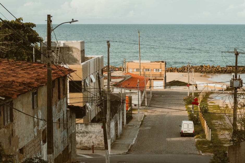 Charming coastal street leading to the ocean in Natal, Brazil, showcasing urban and sea scenery.