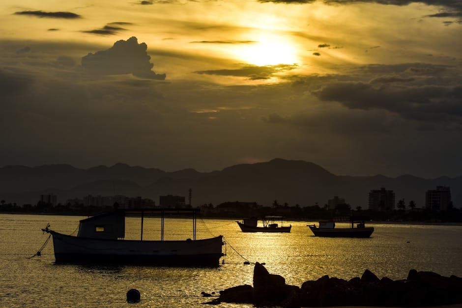 Peaceful sunset scene with boats on the water in Caraguatatuba, Brazil.