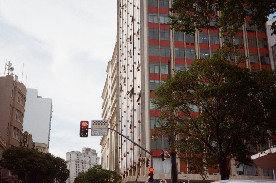 A vibrant urban street scene in Curitiba, Brazil, featuring modern buildings and traffic lights.
