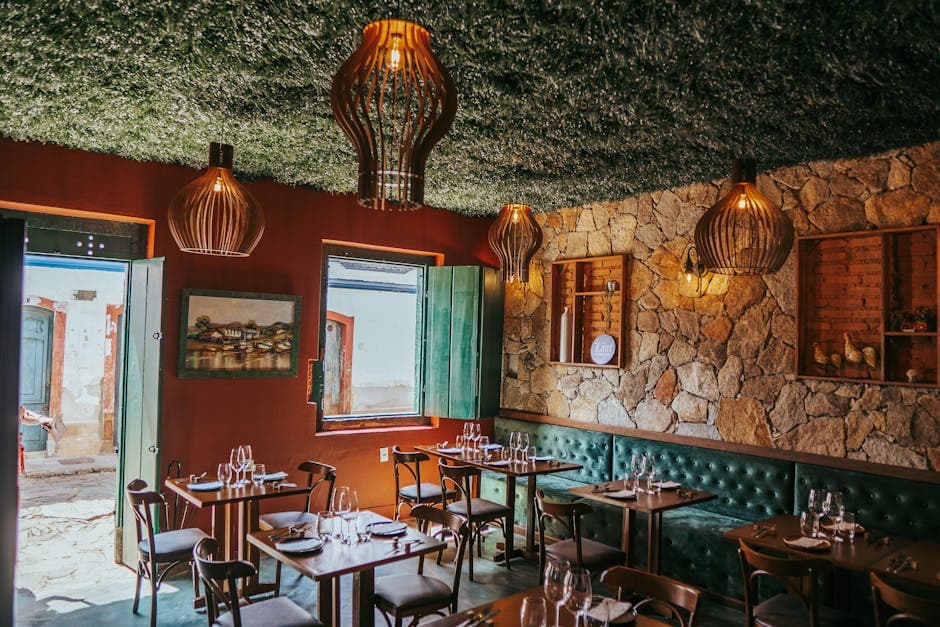 Cozy restaurant interior with rustic decor and stone walls in Tiradentes, Brazil.