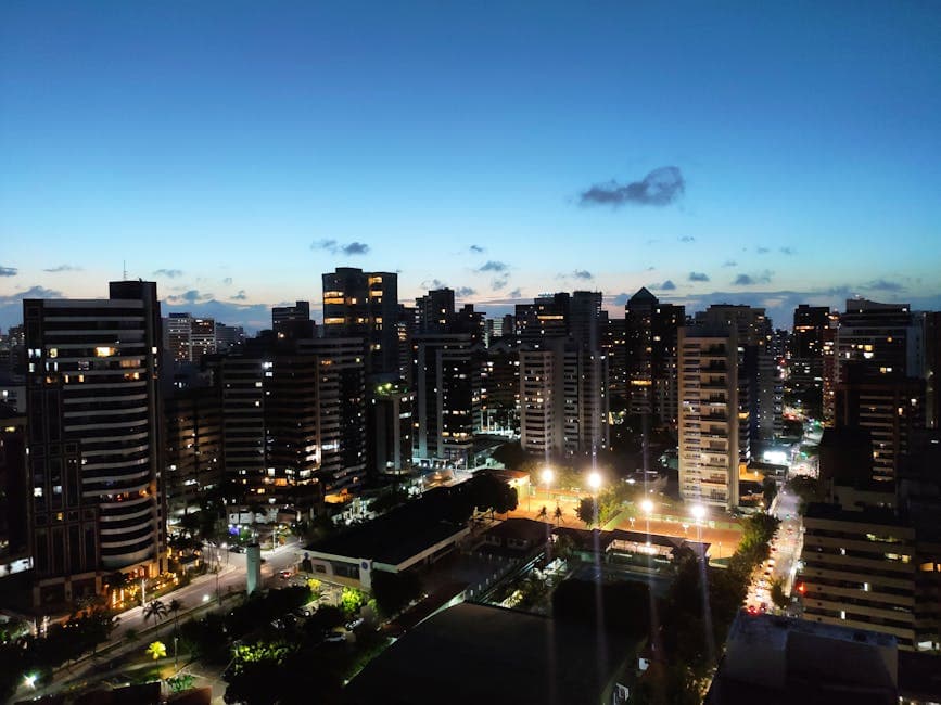 Aerial view of Meireles neighborhood in Fortaleza, Brazil during evening with illuminated skyscrapers.