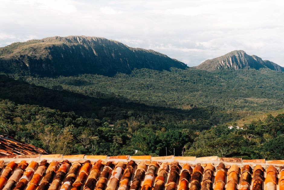 Explore the lush landscape and historic rooftops in Tiradentes, Brazil.