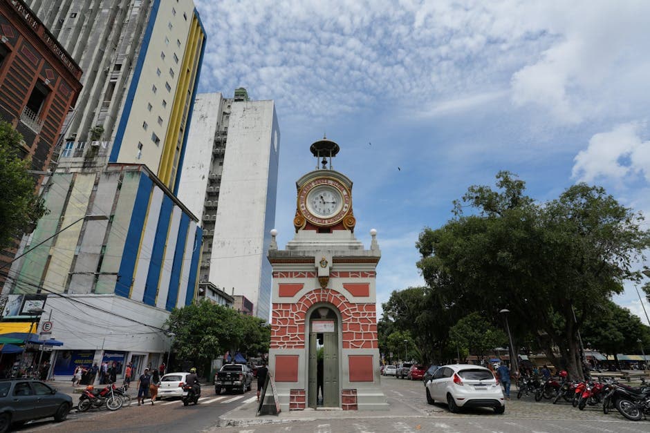 Historic clock tower Relógio Municipal amidst cityscape in Manaus, Brazil.