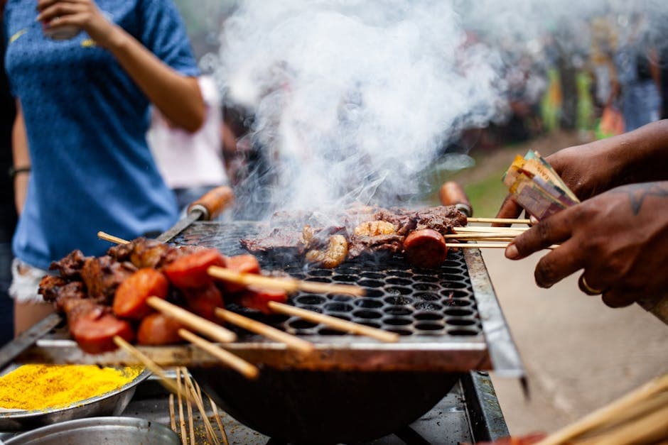 Candid capture of street barbecue grilling with skewers and smoke in Belém, Brazil.