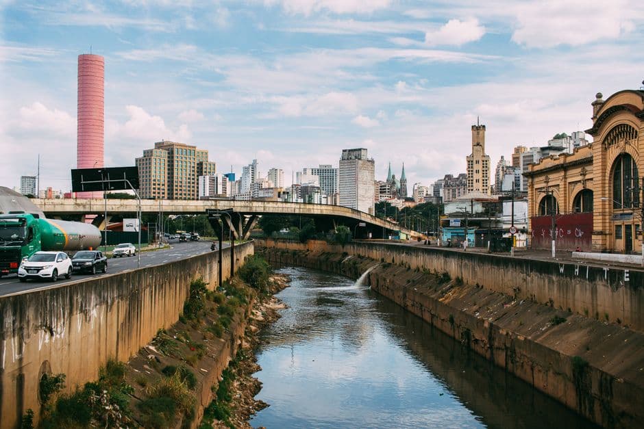 An urban view of São Paulo featuring bridges, buildings, and a historic market.