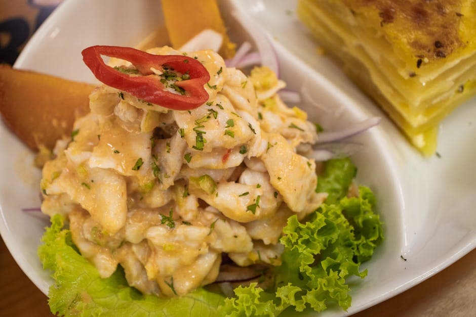 A close-up of traditional Peruvian ceviche with potato pie in Arequipa, Perú.
