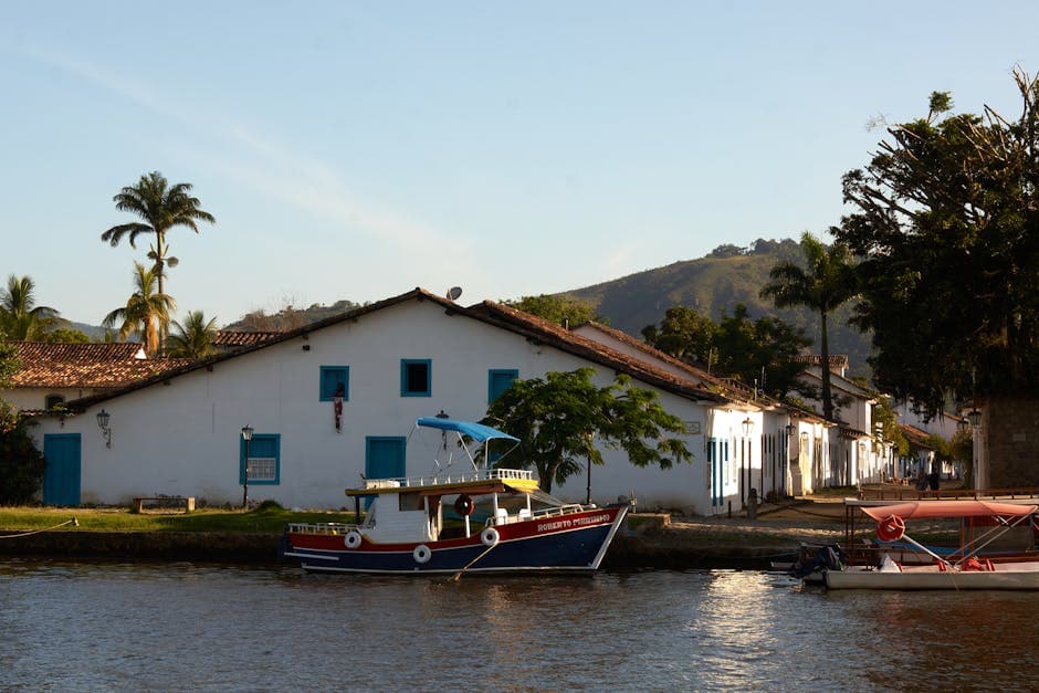 Charming view of a waterfront with boats and colonial houses in Paraty, Brazil.