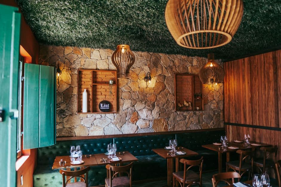 Warm and inviting bistro setting with stone walls and vintage decor in Tiradentes, Brazil.