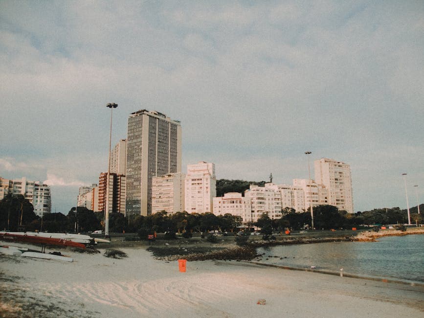 High-rise buildings along the scenic beachfront in Rio de Janeiro, Brazil, under a vibrant sky.