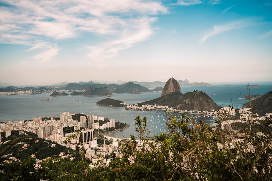 Stunning aerial view of Sugarloaf Mountain in Rio de Janeiro, showcasing vibrant cityscape and ocean.
