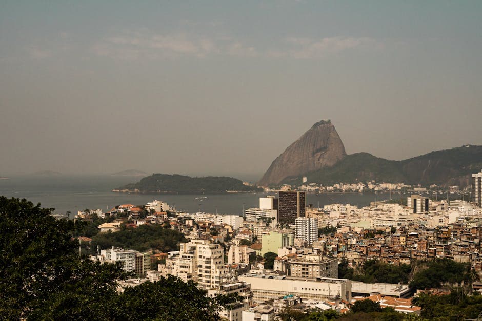 Aerial view of Rio de Janeiro highlighting the iconic Sugarloaf Mountain and urban landscape.