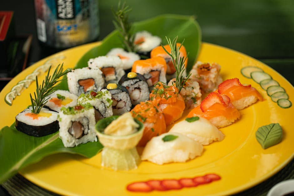 A vibrant display of assorted sushi rolls and nigiri on a yellow plate, perfect for gourmet and culinary themes.