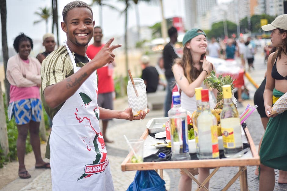 A joyful street scene in Rio de Janeiro, Brazil, with people celebrating around a drink stand.
