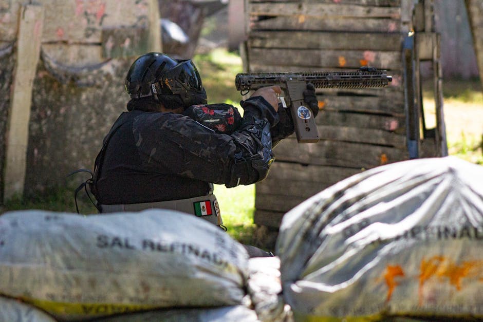 A player in protective gear engaged in a dynamic outdoor paintball match.