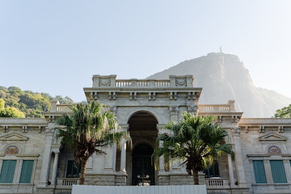 Classic mansion facade with Christ the Redeemer on Corcovado Mountain in Rio de Janeiro, Brazil.