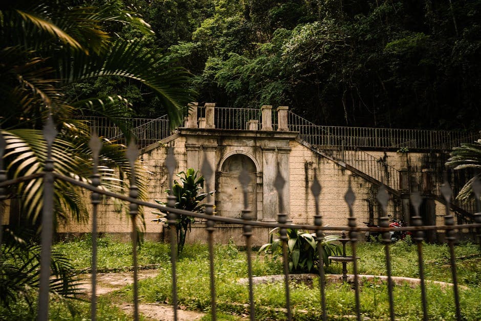 Vintage stone structure surrounded by lush vegetation in Rio de Janeiro, Brazil.