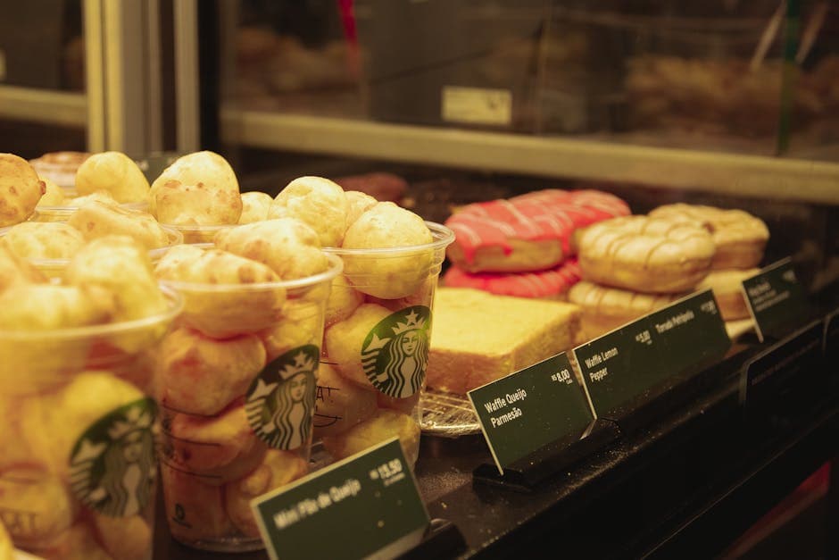 A close-up view of various pastries and baked goods on display in a café setting.