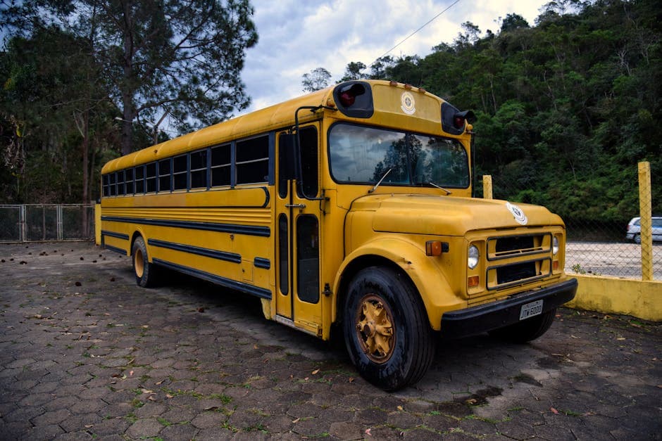 Vintage yellow school bus parked outdoors in Ubatuba, São Paulo, Brazil. A nostalgic travel scene.