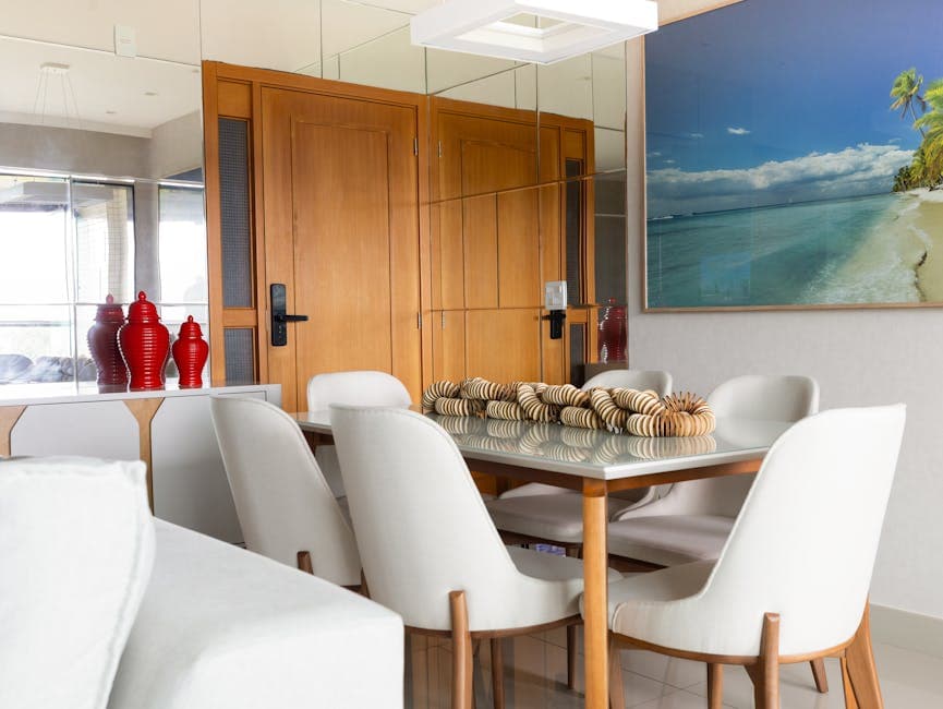 Elegant dining room with mirror decor and beach artwork in Salvador, Brazil.