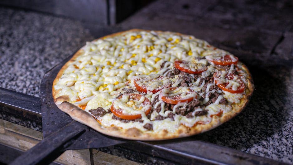 Freshly baked Brazilian pizza with diverse toppings including cheese, corn, and beef, cooked to perfection.