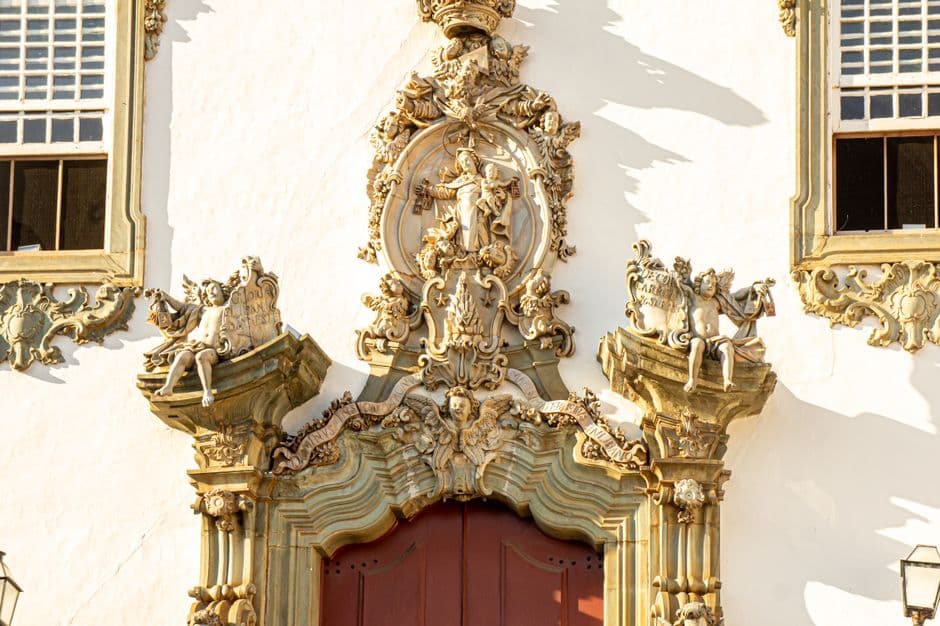 Detailed facade of a church in São João del Rei, showcasing Baroque architecture and sculptures.