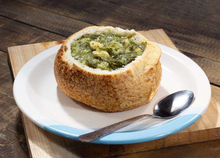 Savor a hearty soup served in a bread bowl, perfect for rustic dining experiences.