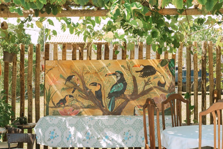 Charming outdoor setting with vibrant toucan mural under a leafy canopy in Brazil.