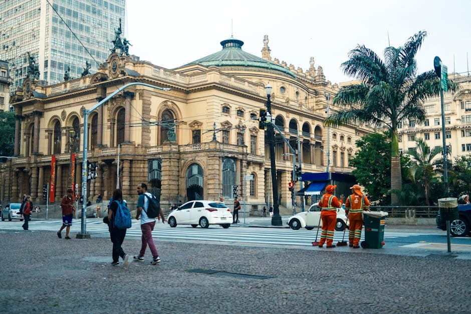 Street view of São Paulo Municipal Theatre with pedestrians and workers in Sao Paulo.