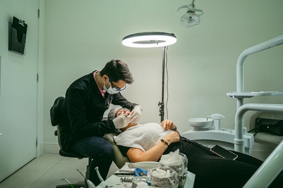 Dentist examines patient using modern equipment in a bright clinic.