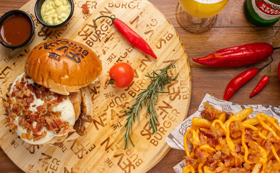 Mouth-watering burger with fries and chili, captured in vibrant color in Maceió, Brazil. Perfect for food lovers.
