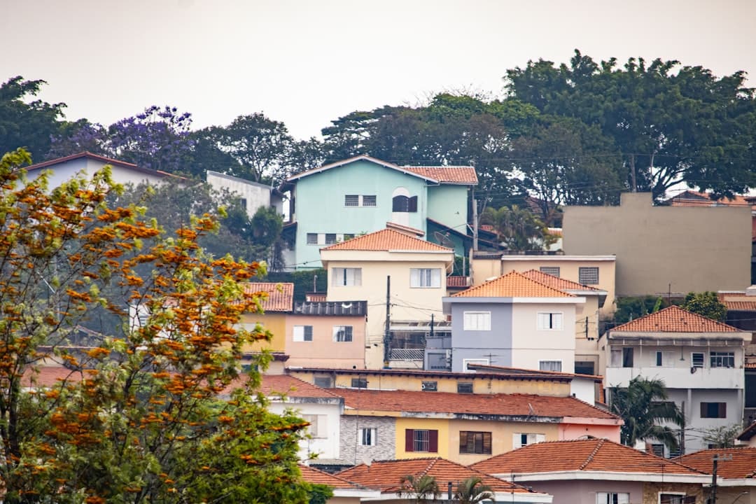 a group of buildings with trees in the back