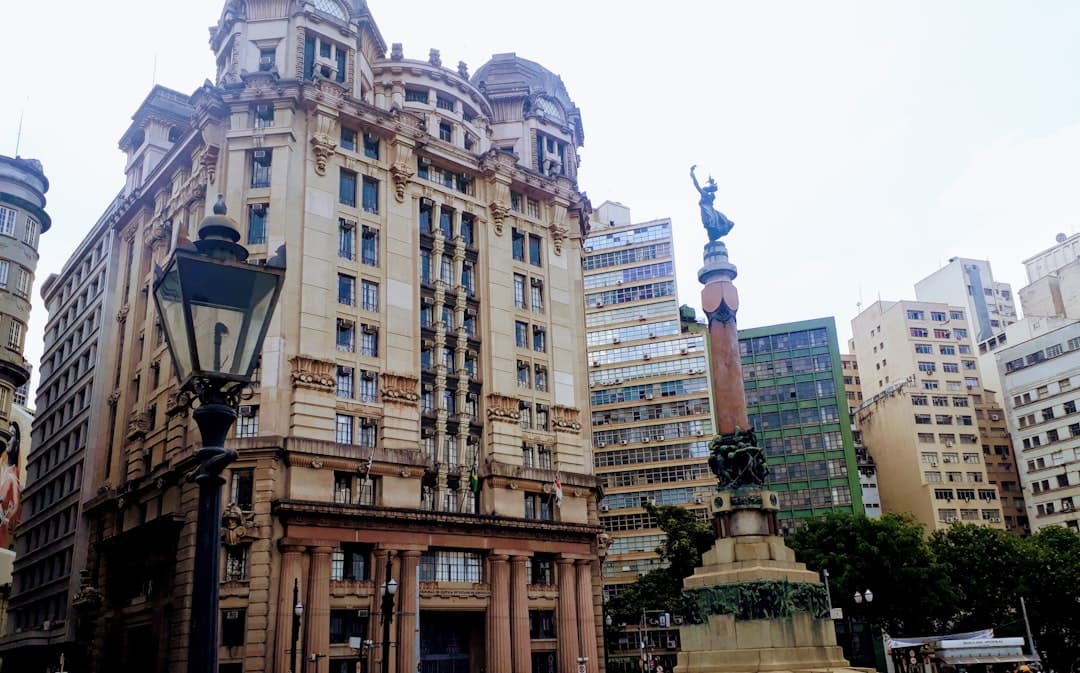 a tall building with a statue in front of it