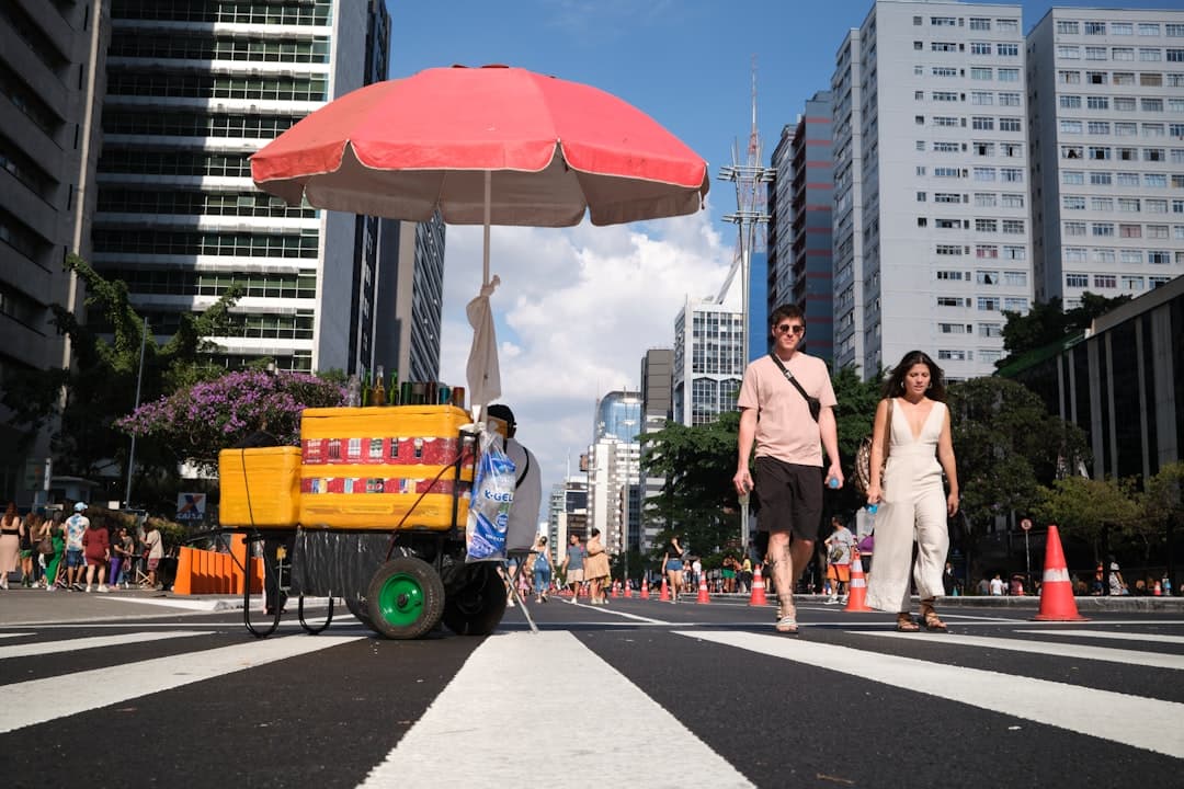 a man pushing a cart down a city street