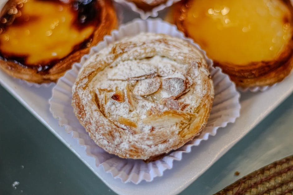 A tempting assortment of freshly baked Brazilian pastries, including almond pastries on a tray.