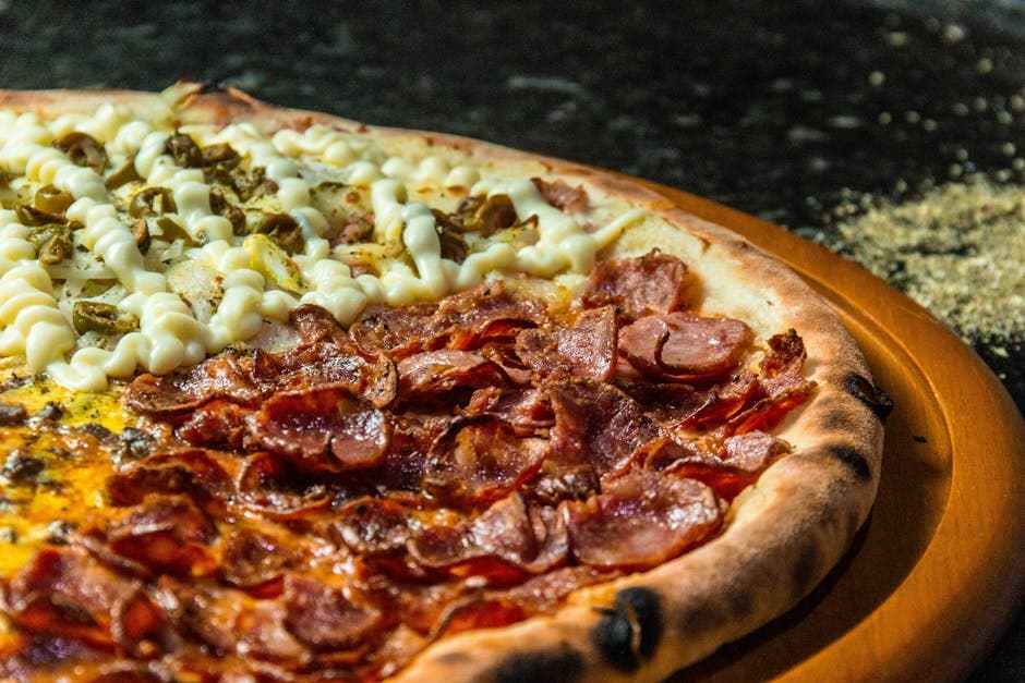 Close-up of a pepperoni and cream cheese pizza on a wooden board, perfect dinner meal.