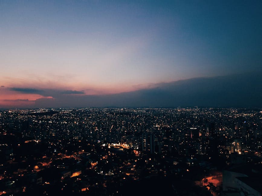 Stunning view of Belo Horizonte skyline at dusk with vibrant city lights and a colorful sky.