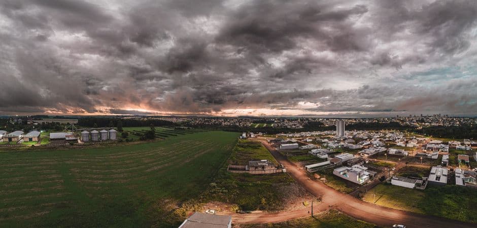 Panoramic aerial view of Campo Mourão, Brazil with dramatic skies and rural landscapes at sunset.