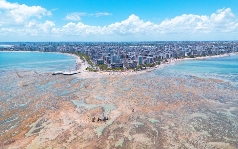 Stunning aerial view of Maceió, Brazil showcasing the vibrant coastline, urban landscape, and turquoise waters.