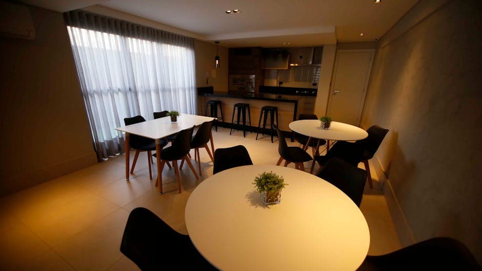 Cozy dining room featuring sleek tables and chairs, accentuated with minimalistic decor.