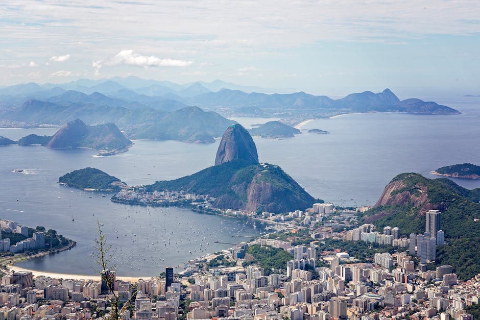 A breathtaking aerial view of Rio de Janeiro featuring Sugarloaf Mountain and Guanabara Bay.