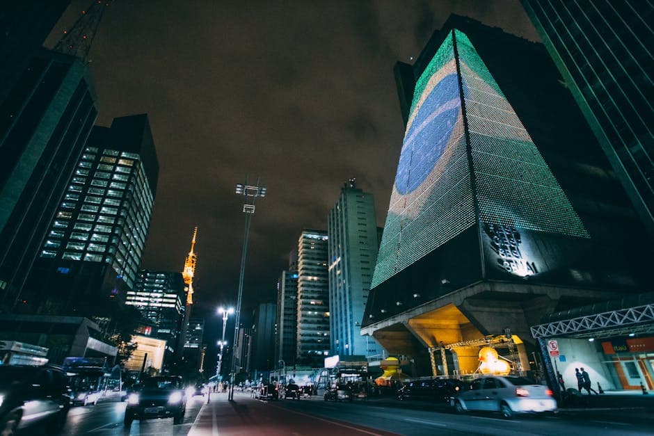 A dynamic nighttime cityscape in Sao Paulo featuring modern skyscrapers and street lights.