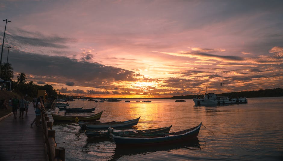 A mesmerizing sunset over a Brazilian bay with docked boats, capturing the golden hour ambiance.